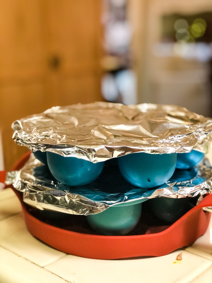 egg bite molds covered in foil and stacked on each other