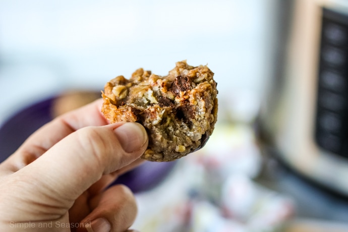 closeup of banana oatmeal bite in a hand with a bite taken out of it