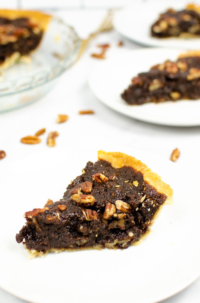 slices of chocolate pecan pie on white plates