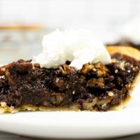 slice of chocolate pecan pie with whipped cream
