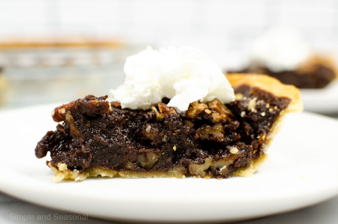 slice of chocolate pecan pie with whipped cream