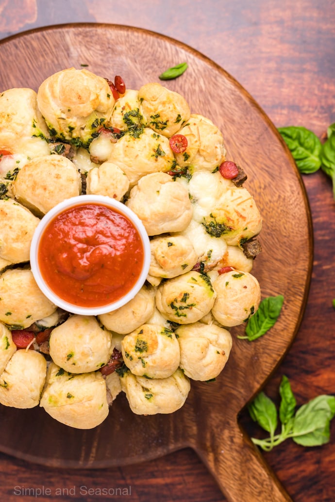 cooked garlic butter pizza monkey bread on a wooden platter