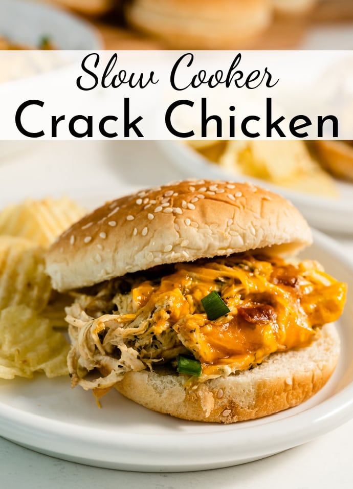 hamburger bun stuffed with slow cooker crack chicken on a plate with chips