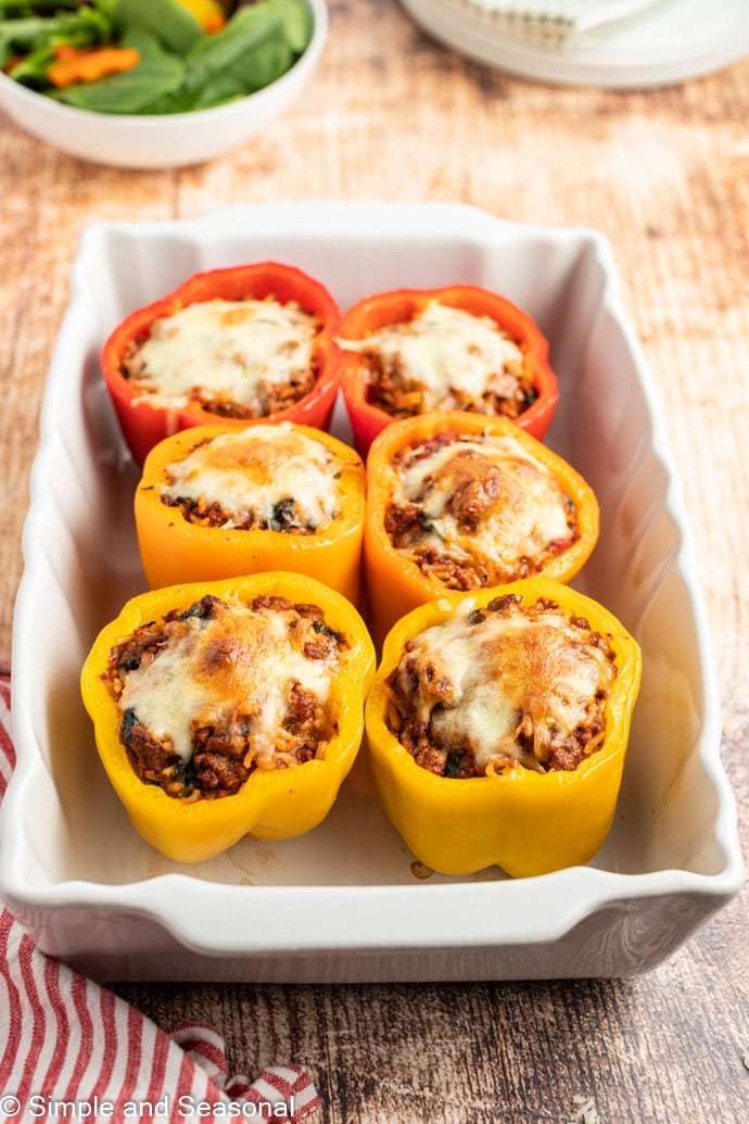 baked stuffed peppers in a white pan