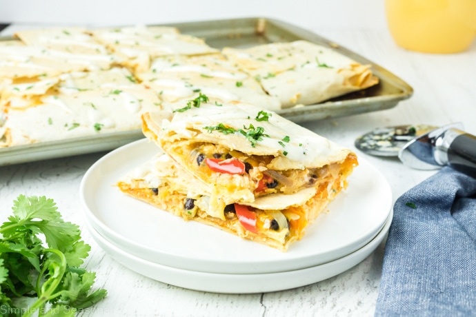 quesadillas pieces on  plate with the sheet pan in the background