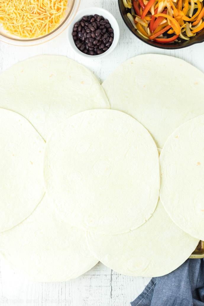 large tortillas laid out over a sheet pan