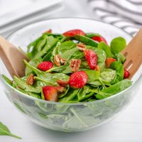 large salad bowl filled with spinach strawberry salad