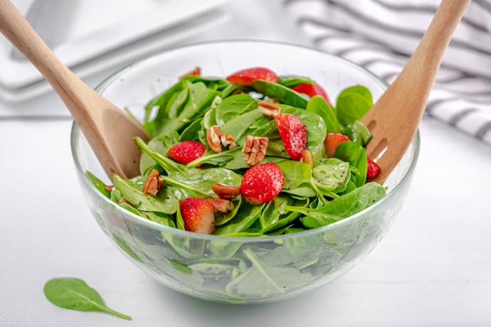 large salad bowl filled with spinach strawberry salad