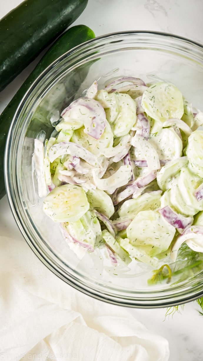top down view of bowl of mixed creamy cucumber salad