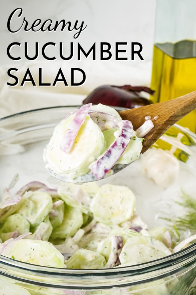 wooden spoon with cucumber slices and red onion; text label reads Creamy Cucumber Salad
