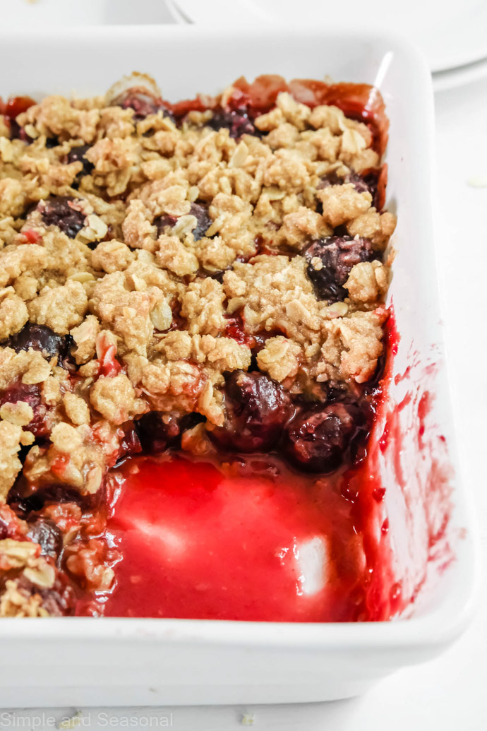 closeup of cherries under golden crumb topping