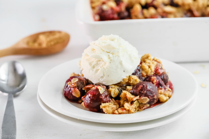 cherry crumble topped with vanilla ice cream