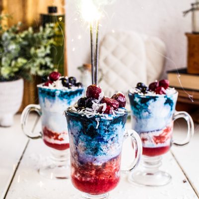 layered drinks with fresh fruit toppings and sparklers