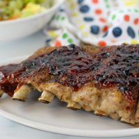 cooked ribs on a white plate