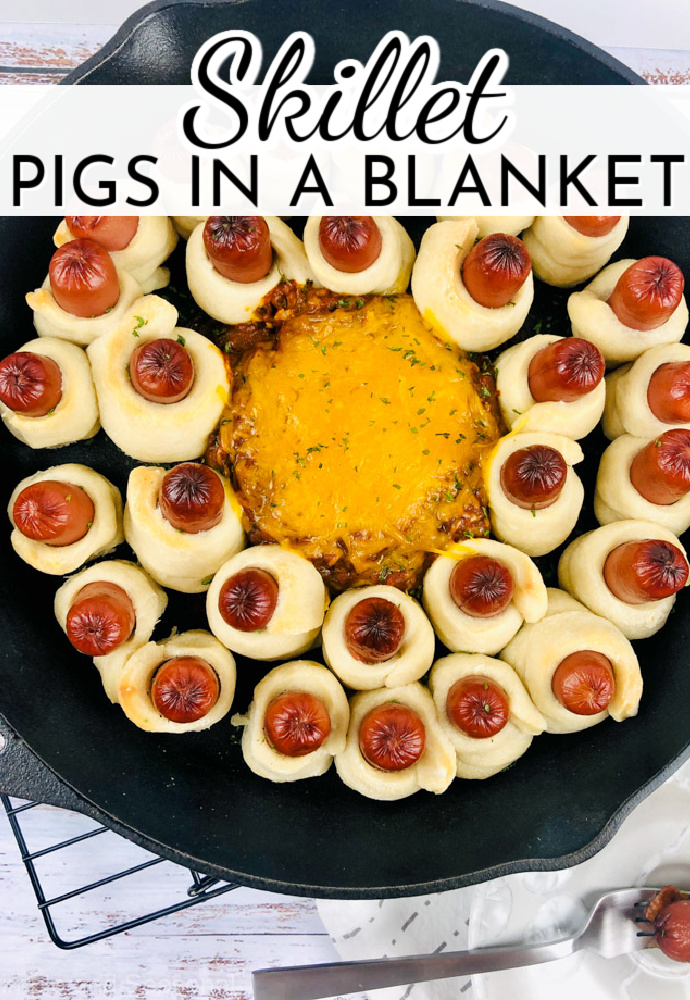 hot dogs wrapped in dough and baked in a skillet surrounding chili; text label reads: Skillet Pigs in a Blanket