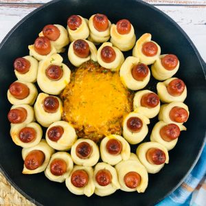 top down image of skillet of cooked pigs in a blanket