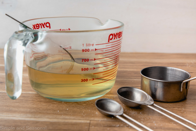 glass measuring cup with pickling liquid