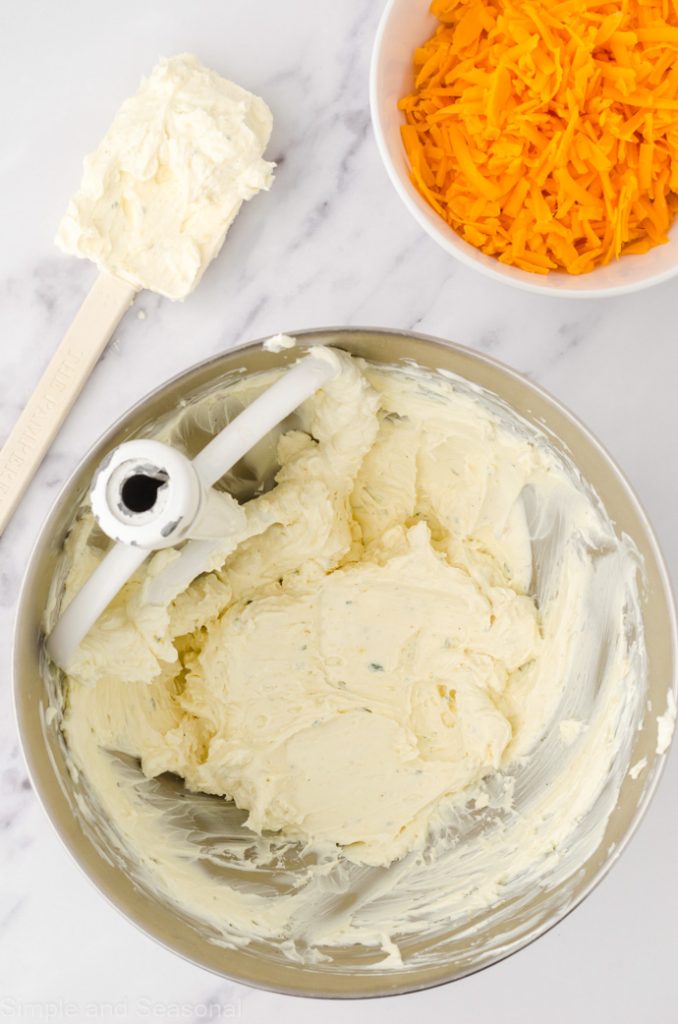 cream cheese in a mixing bowl with spatula