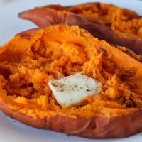 cooked sweet potato on a plate with butter