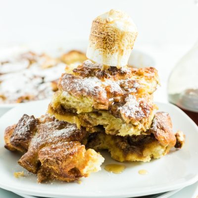 Fluffernutter French Toast Bake on a white plate with toasted marshmallow on top