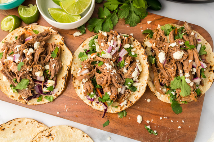 three tacos on a tray