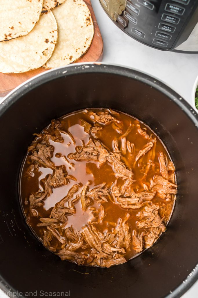 cooked and shredded beef in the pot
