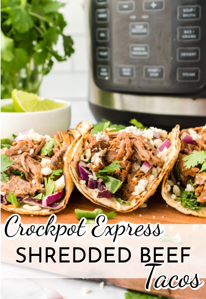 tacos on a serving tray with a pressure cooker in the background