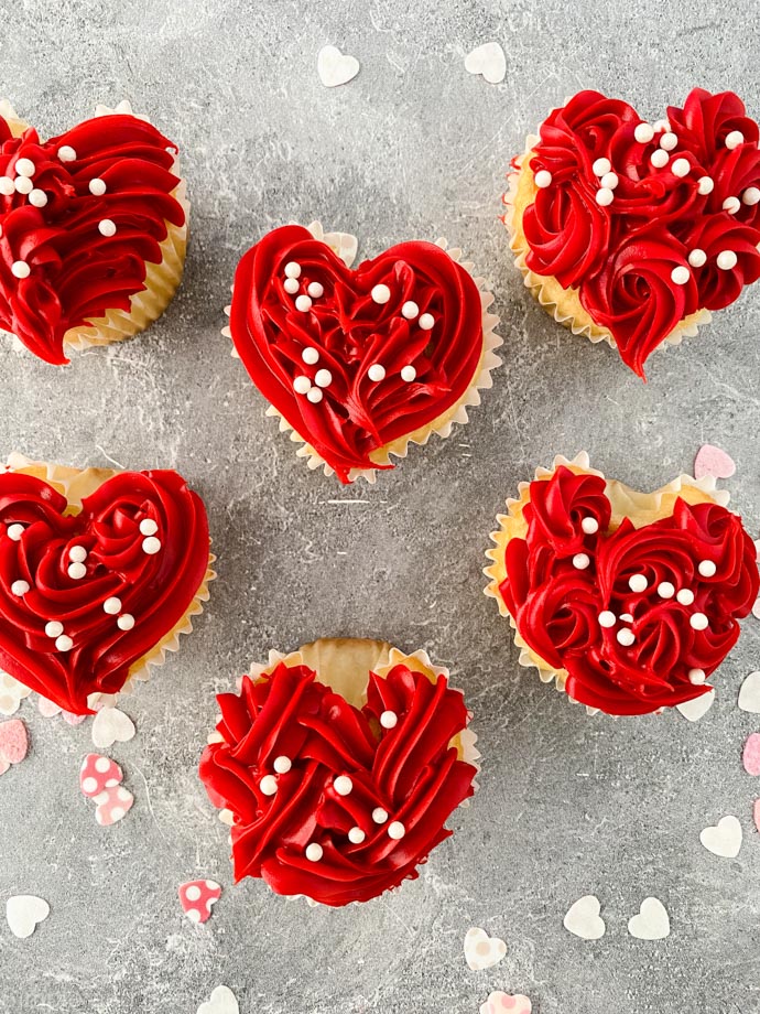 completed heart cupcakes with red frosting