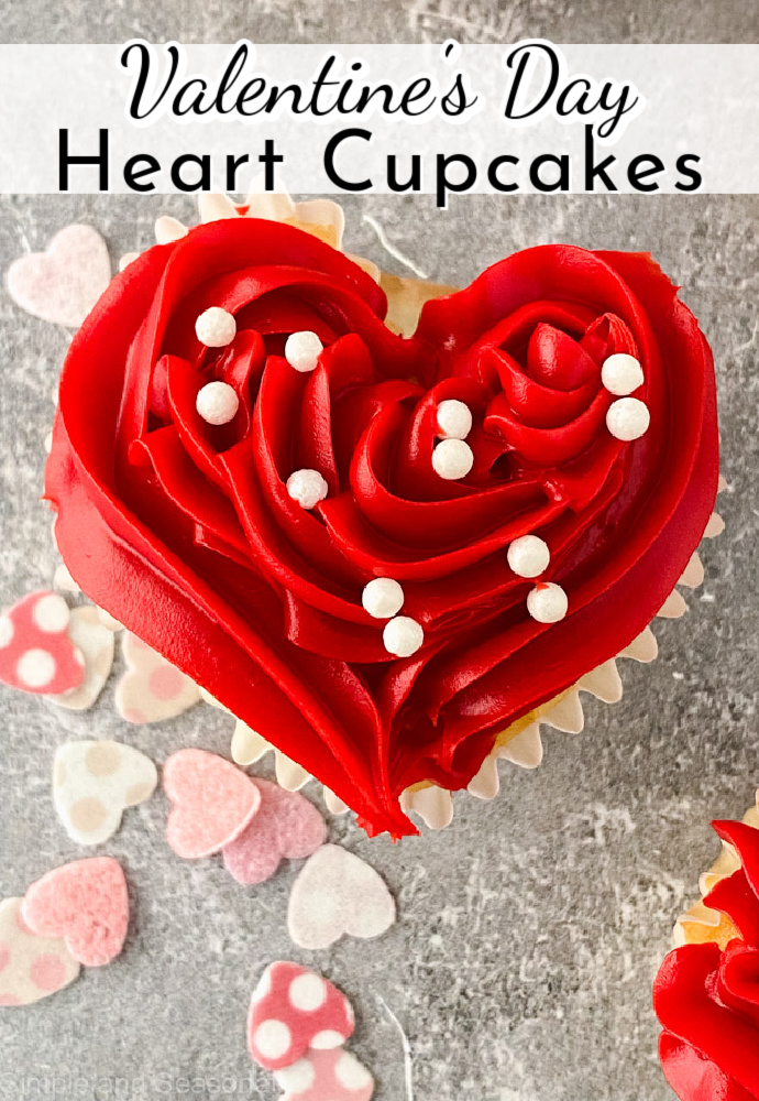 red frosted heart shaped cupcake with text label that reads: Valentine's Day Heart Cupcakes