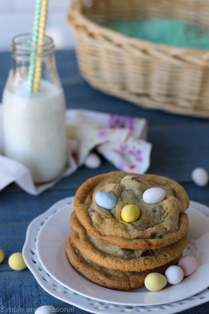 mini egg cookies stacked on a plate with Easter basket in the background