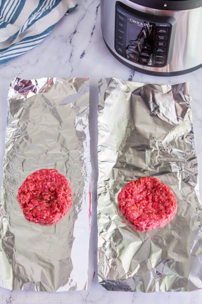 top down view of hamburger patties on aluminum foil