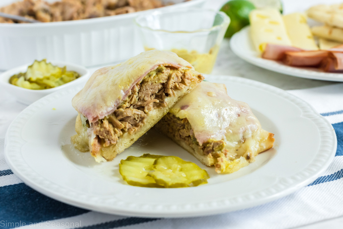 cuban sandwich on a plate with sliced pickles