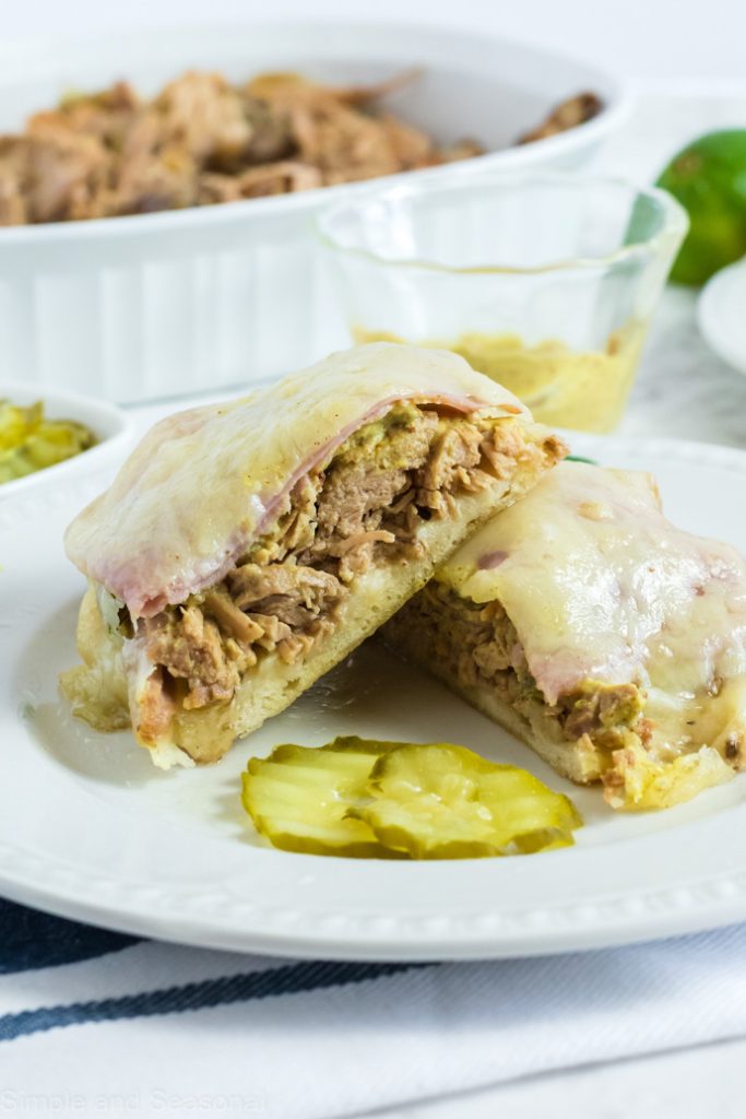 sliced cuban sandwich with pulled pork in the background