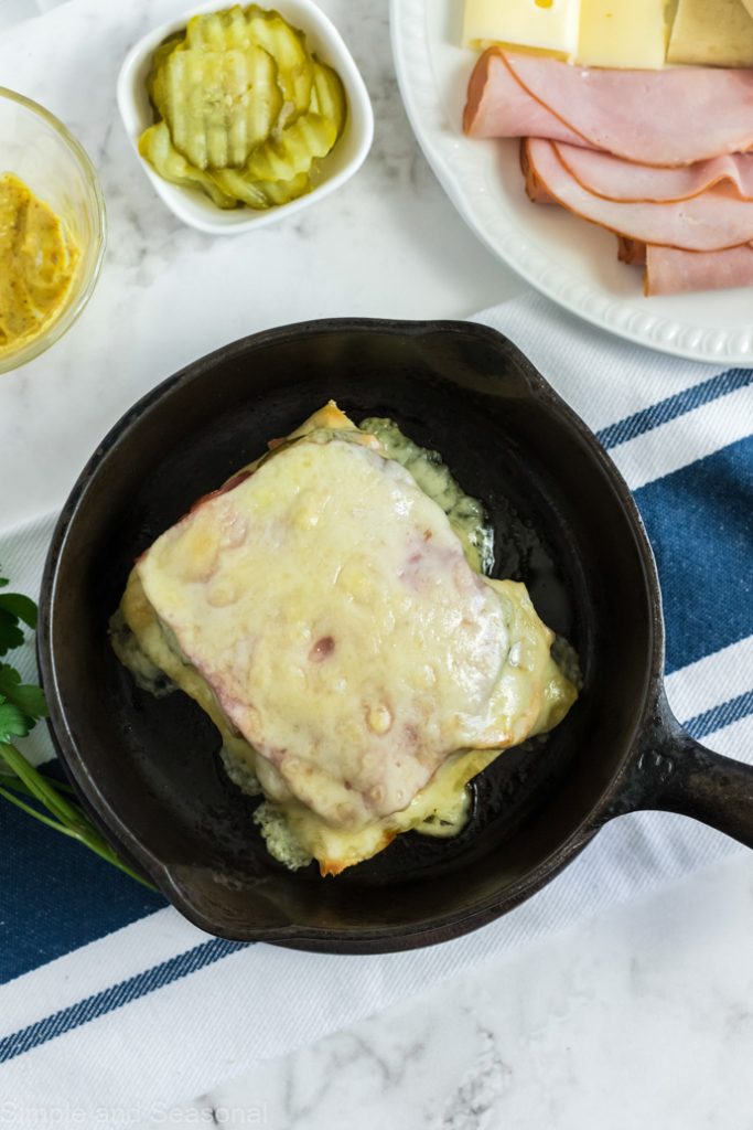 sandwich in a skillet with cheese melted on top