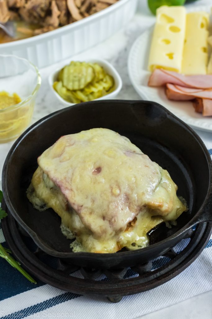 cuban pork sandwich in a skillet with melted cheese