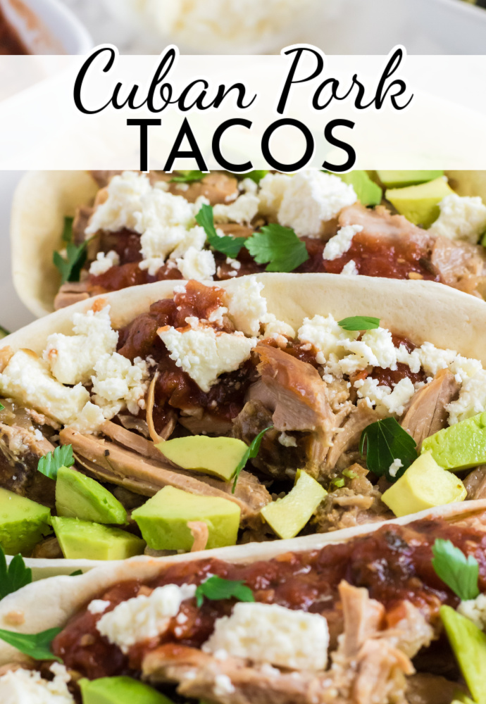 Closeup of shredded pork, cheese, avocado and other toppings in a taco shell; label reads: Cuban Pork Tacos