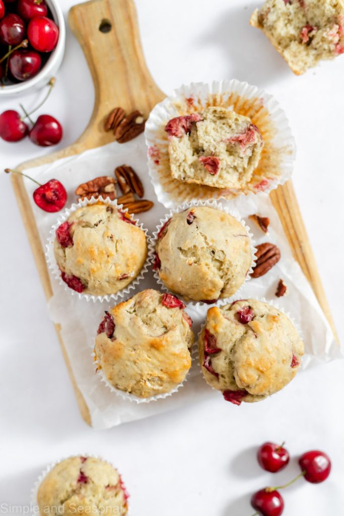 top down view of baked muffins with pecans and cherries