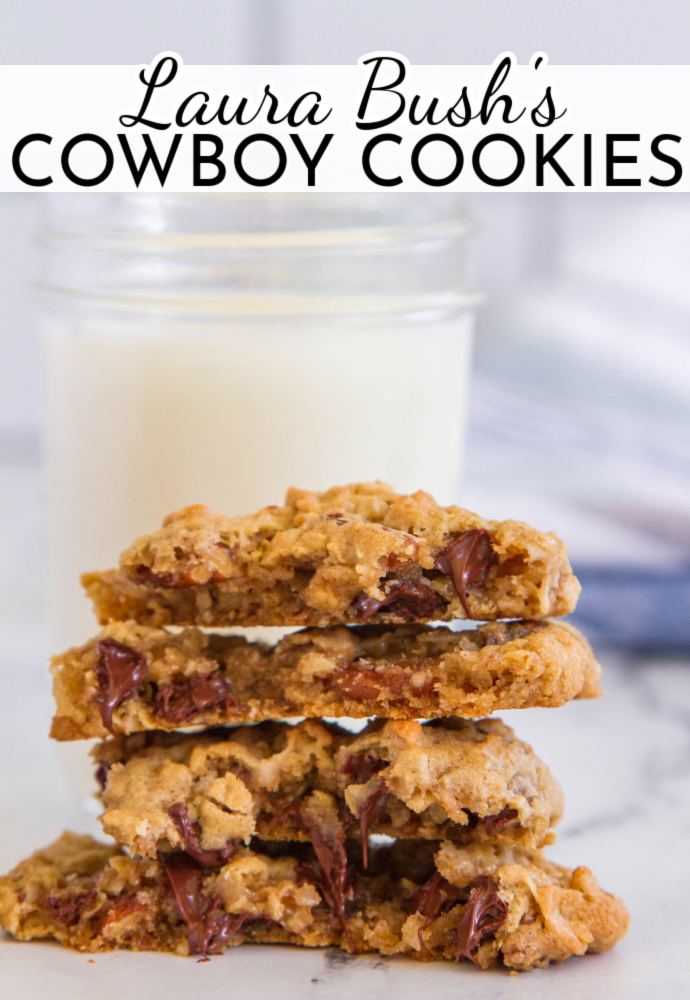 stack of cookies cut in half to show melty chocolate centers with glass of milk in the background.