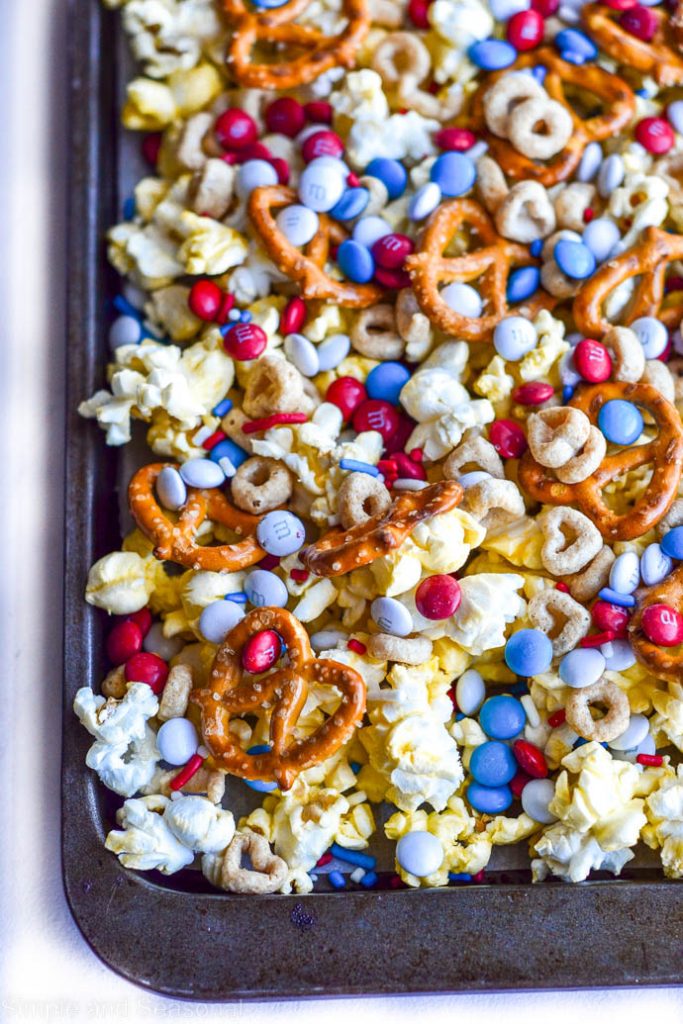 baking sheet with snack mix spread out over it