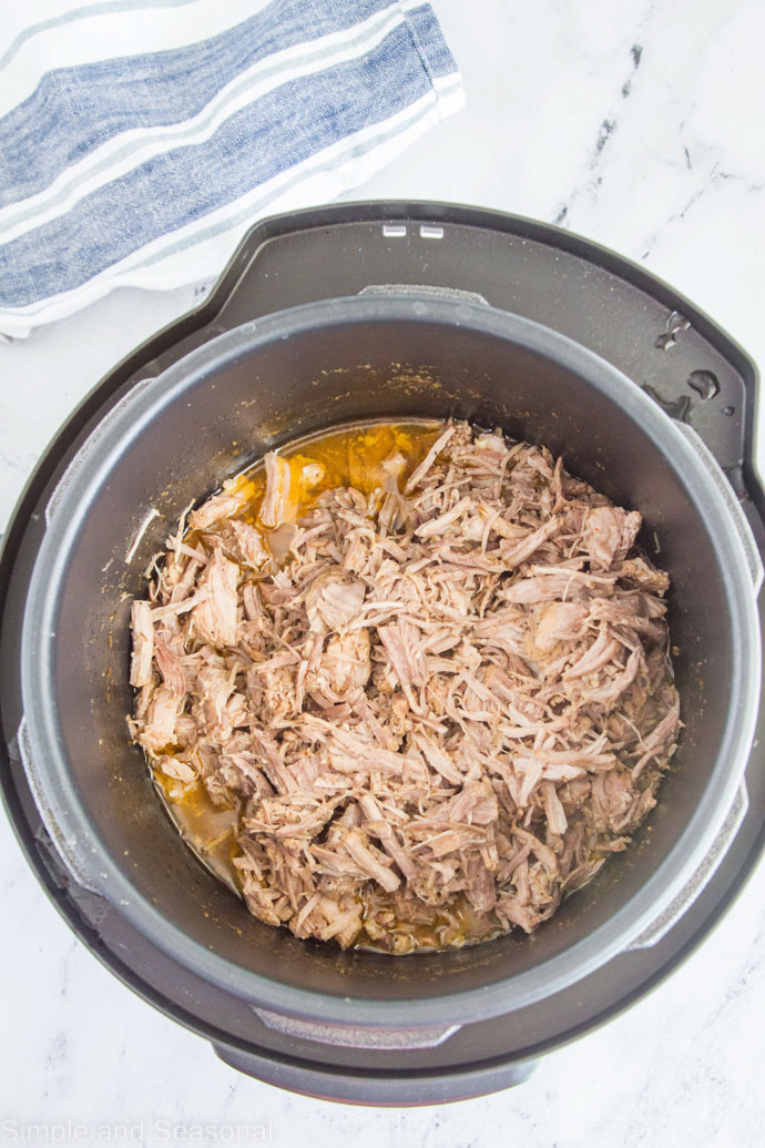 pork cooked and shredded in the pot