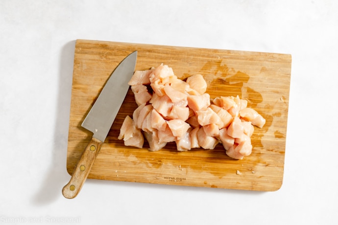 chopped raw chicken on a cutting board