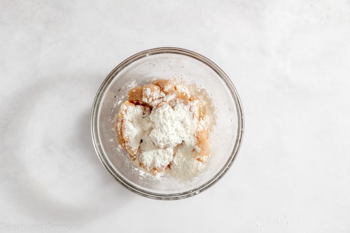 chicken in a bowl with cornstarch mixture