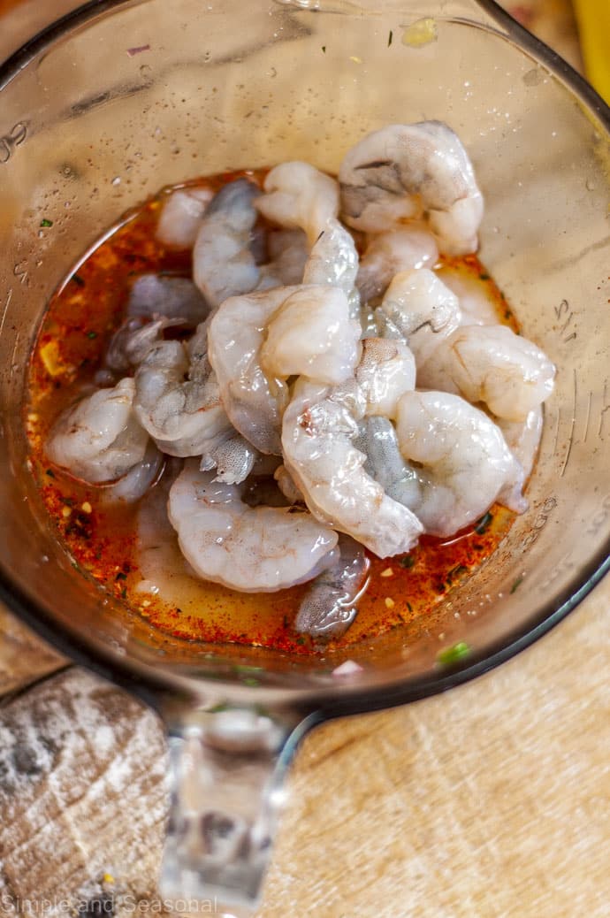 raw shrimp in a bowl with marinade