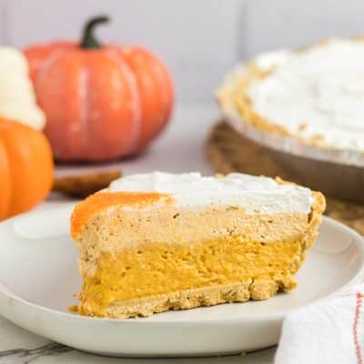 closeup of slice of three layered no bake pumpkin pie