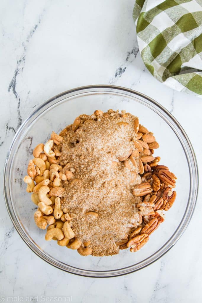 pecans, almonds and cashews in a bowl with spices and sugars
