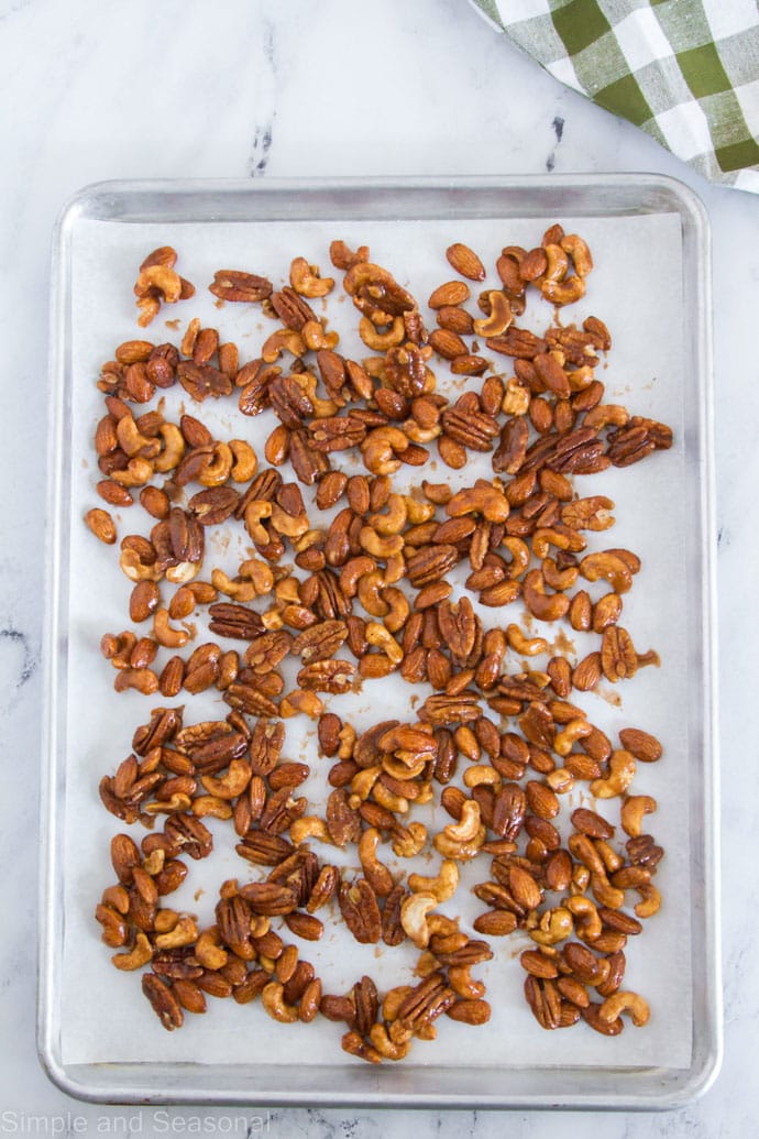 sweet and spicy nuts on a baking sheet ready to bake