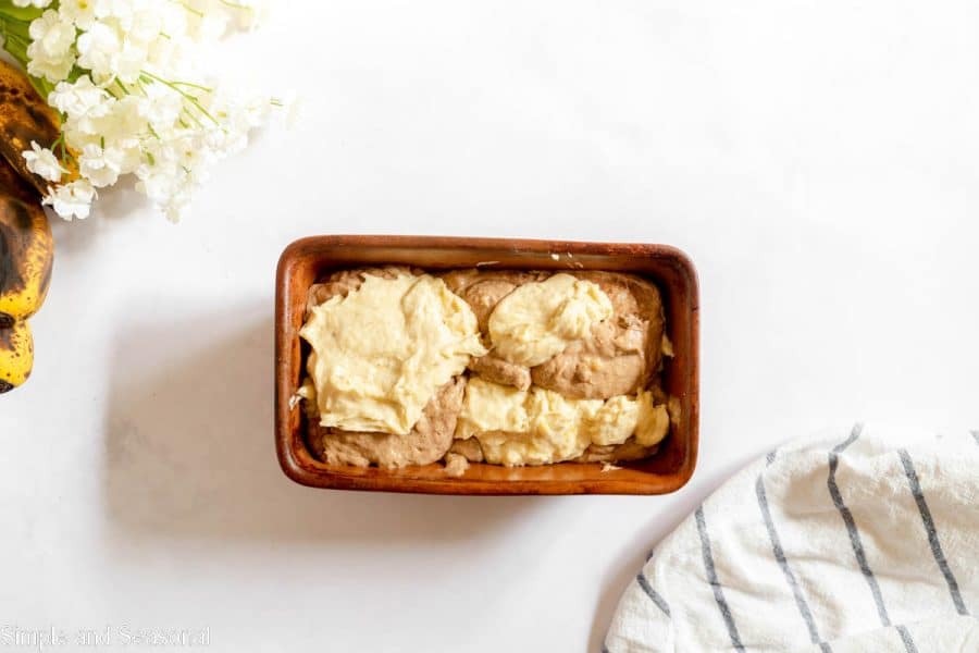 piled of alternating batter in a loaf pan