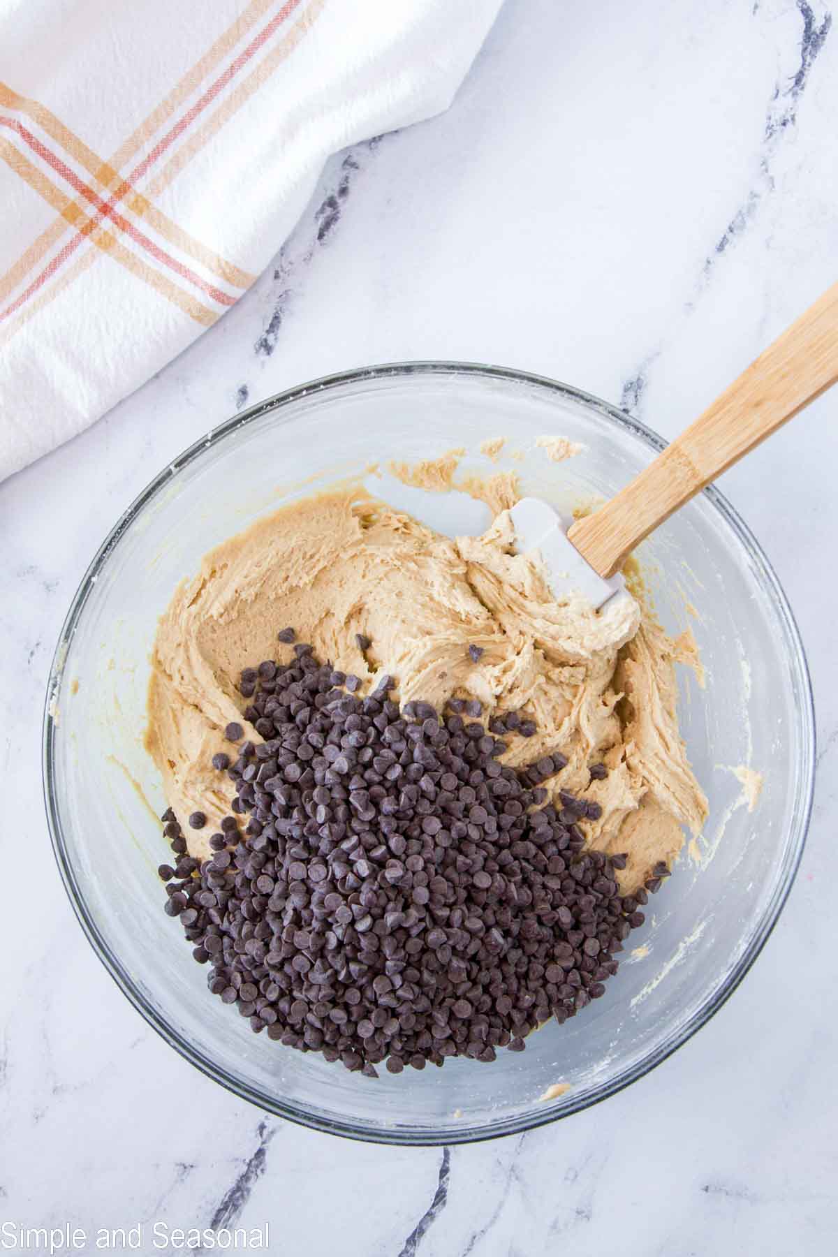 chocolate chips in batter with spatula