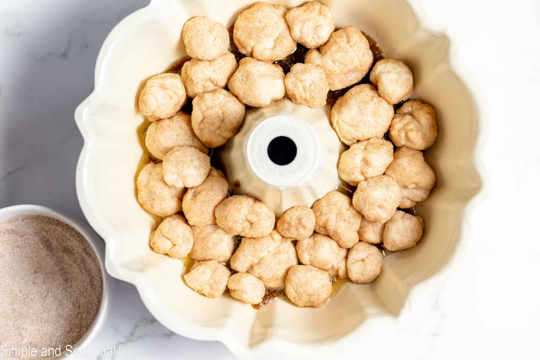 coated dough balls in the bundt pan
