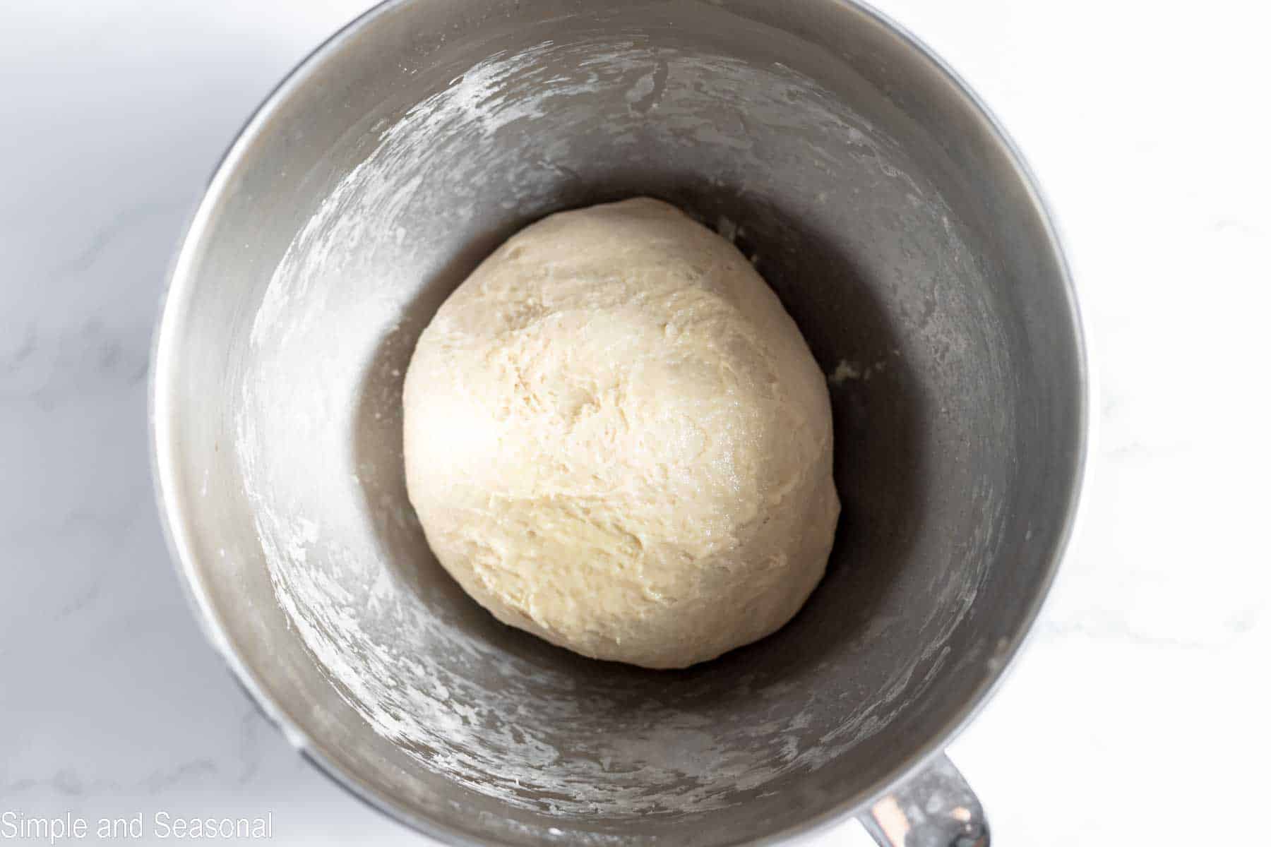 dough ball in the bottom of a mixing bowl